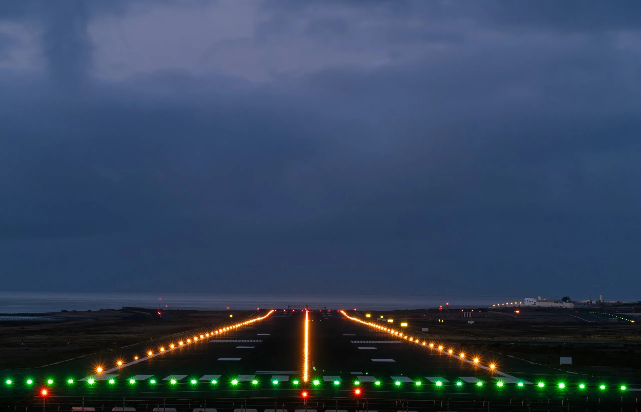 Runway threshold at dusk with green threshold lights and high intensity edge lighting